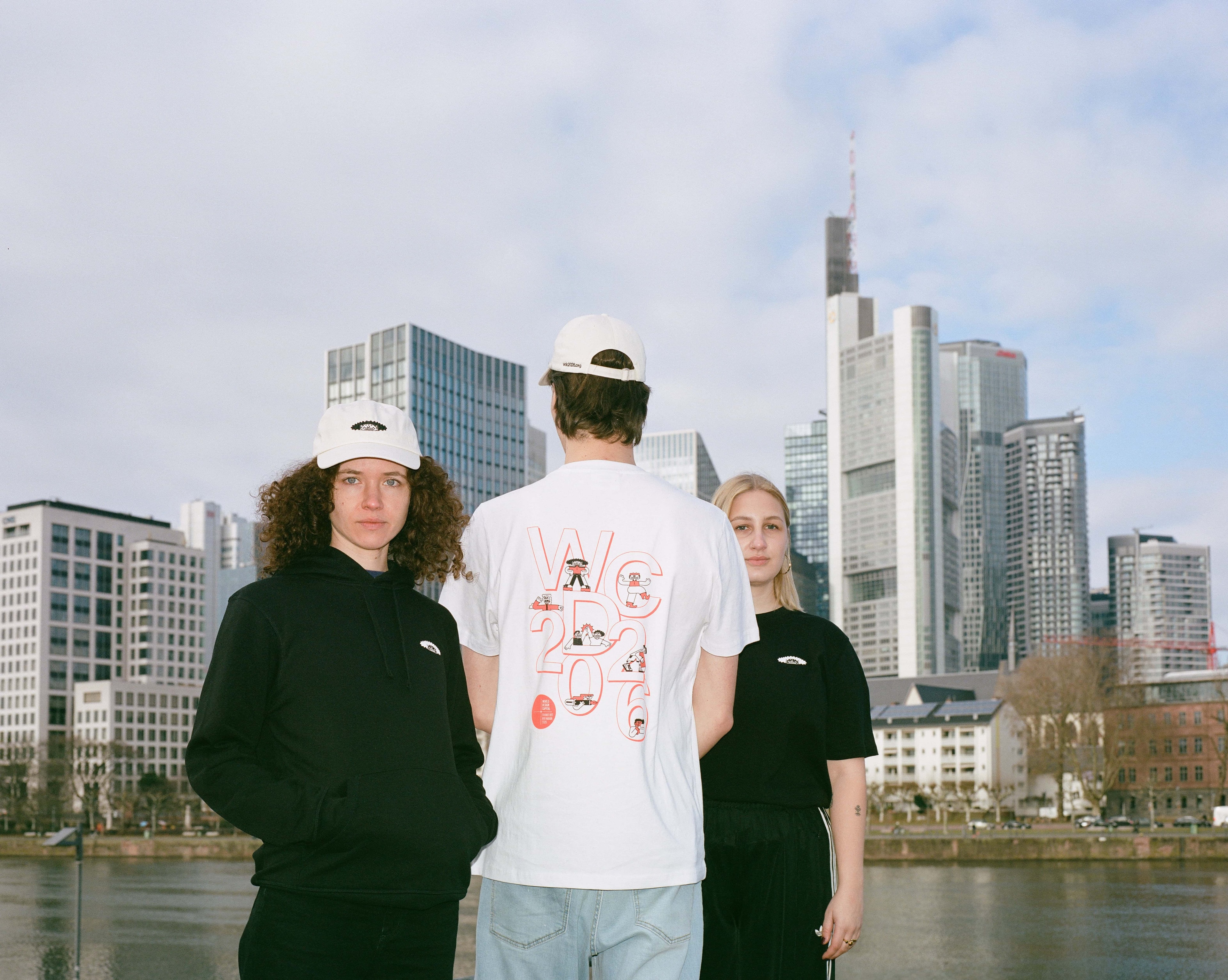 3 Personen stehen im WDC-Merch vor der Frankfurter Skyline