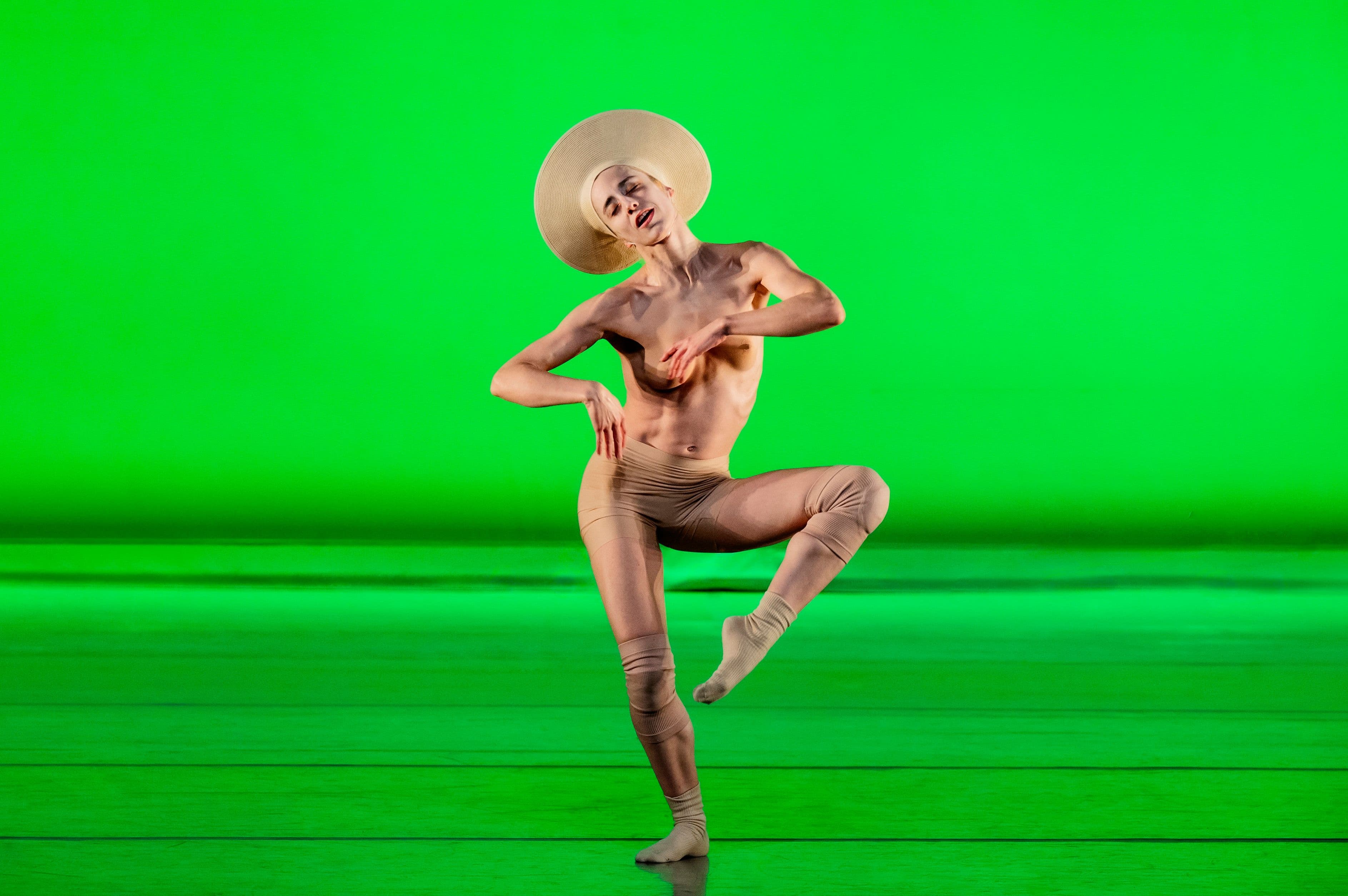 Bild von einer Person während der Performance vor grünem Hintergrund